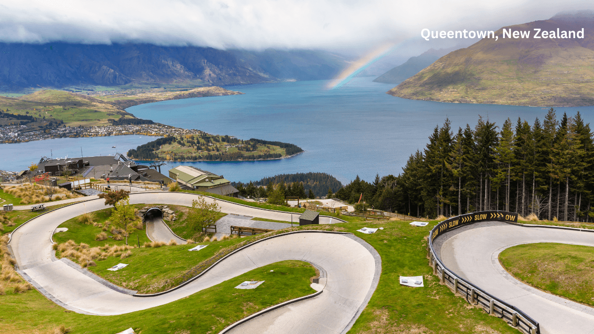 Queenstown New Zealand luge track with Lake Wakatipu and rainbow in background